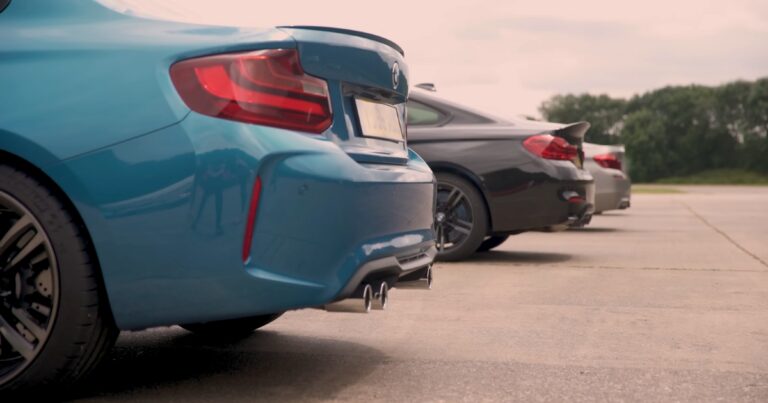 BMW M2 M4 and M6 parked on a street from back side