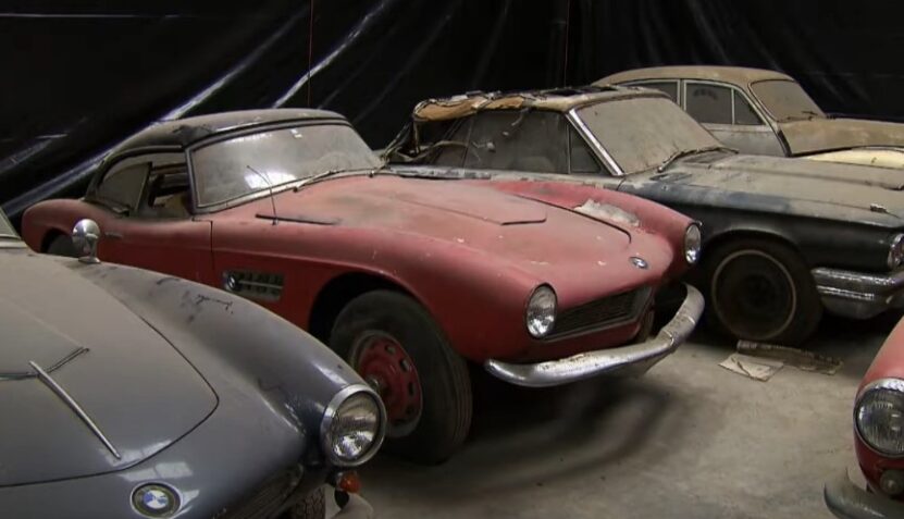 A collection of classic cars, their paint faded and surfaces showing signs of age
