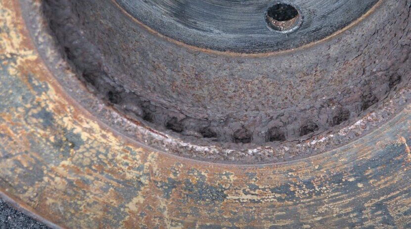 Rust and corrosion are visible along the inner edge of the disc brake