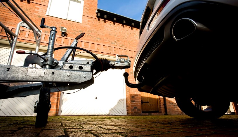 A tow hitch connects a trailer to a car