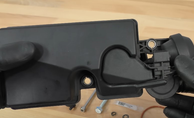 Hands holding new DISA valve part