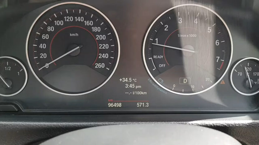 BMW instrument cluster showing speedometer, tachometer, fuel gauge, temperature, and trip data