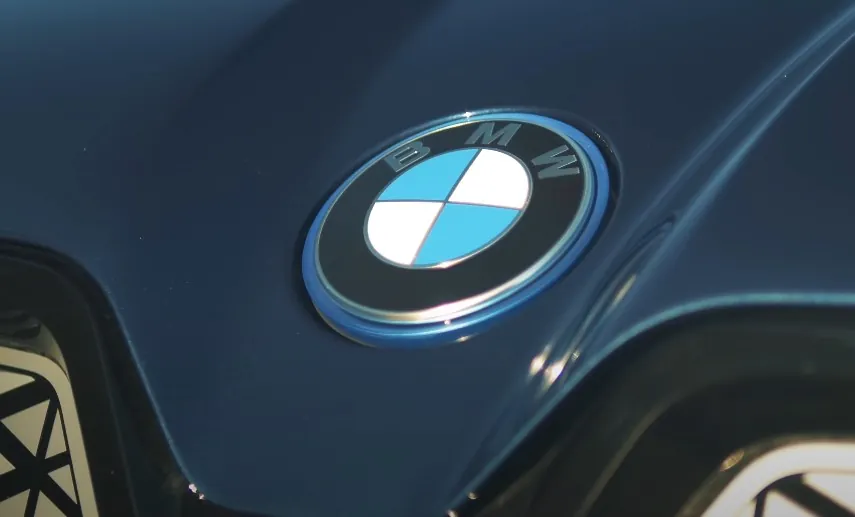 Close up view of a BMW badge on a hood