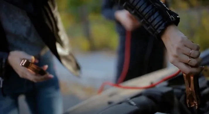 A man preparing jumper cables for his car