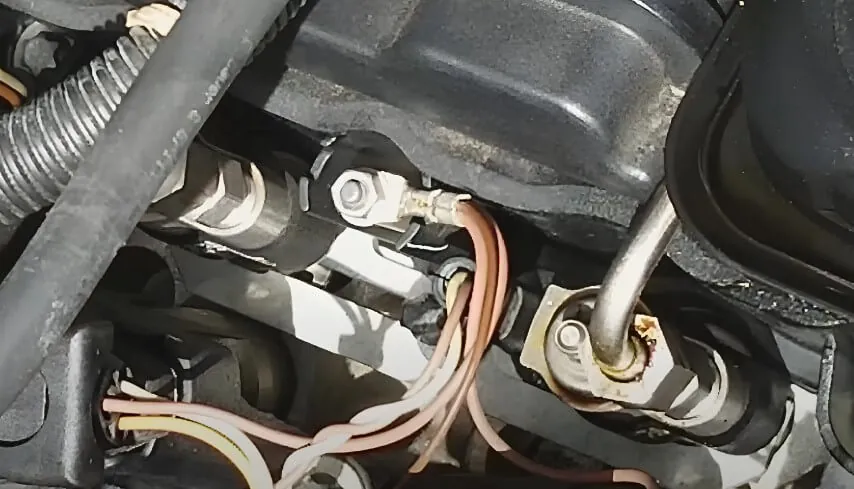 Car engine with various wires and connections visible