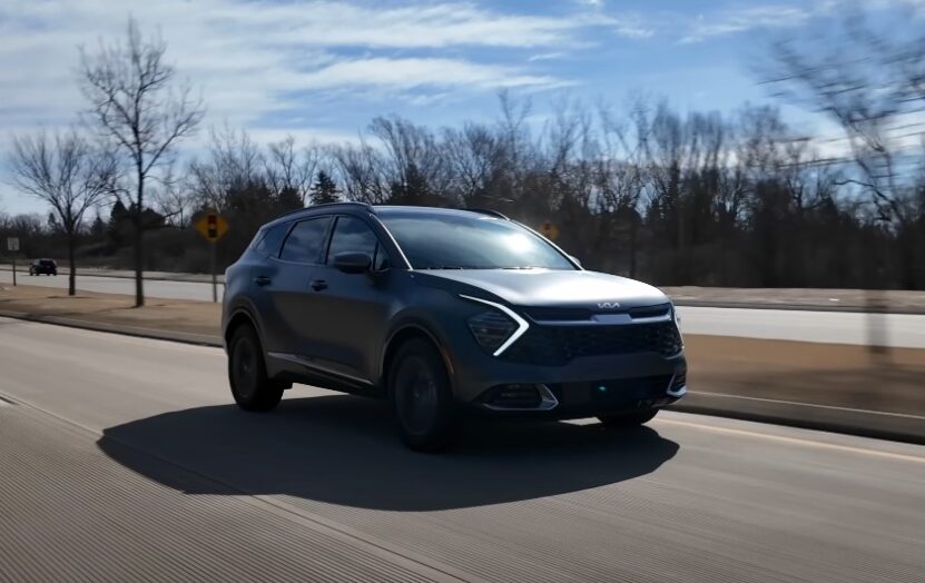 Black Kia Sportage SUV on the road