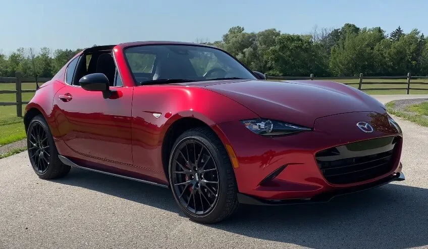 A vibrant red Mazda Miata convertible