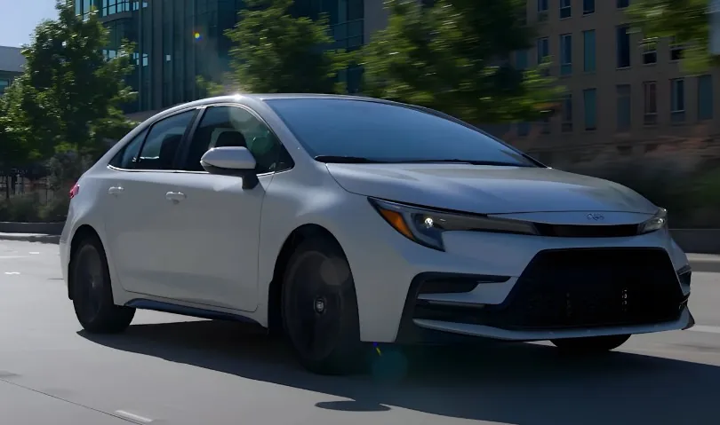 White Toyota Corolla in motion on the road