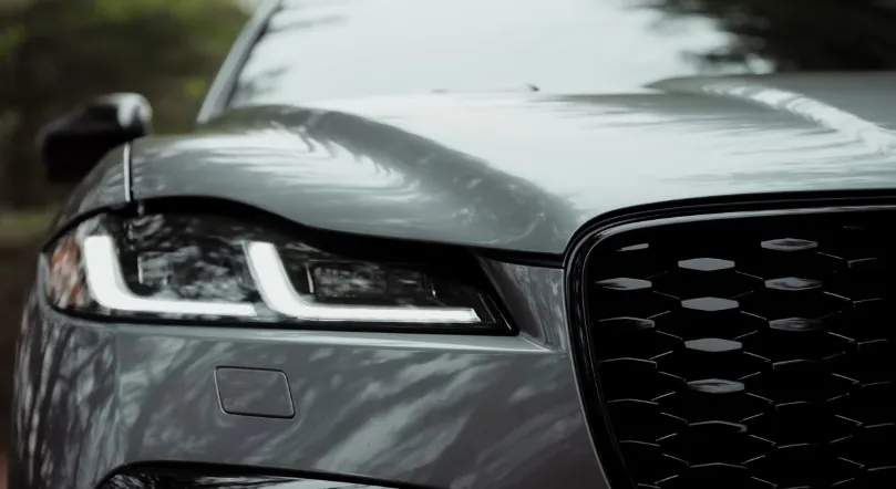 Close-up view of a modern car's front grille and headlight