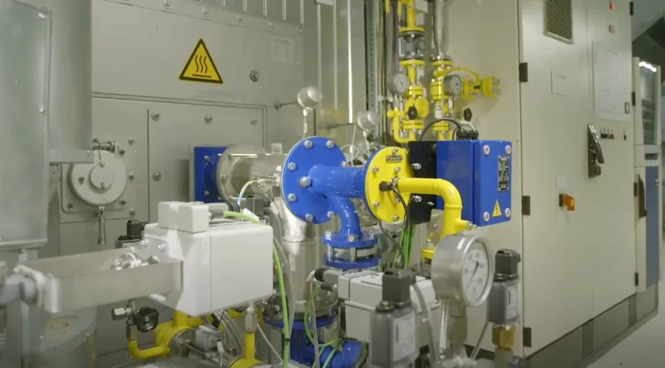 A large industrial machine featuring numerous valves and interconnected pipes