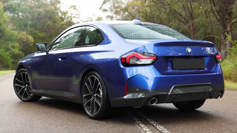 Blue BMW 230i Coupe on a paved road