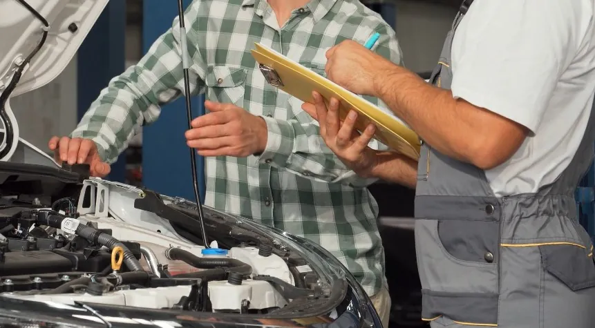 Mechanics collaborating on a vehicle's diagnostics