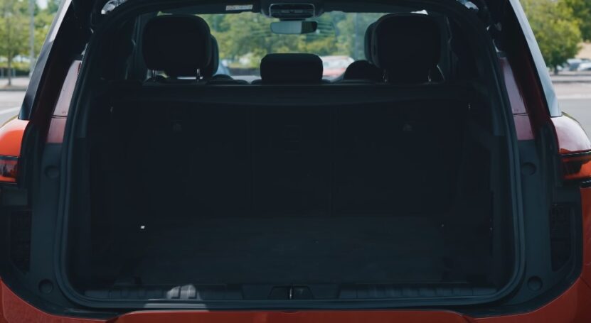 Red car trunk with doors open, showcasing the interior and cargo space