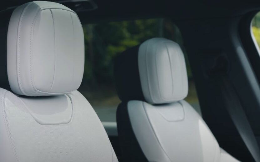 Interior view of a car featuring two white seats