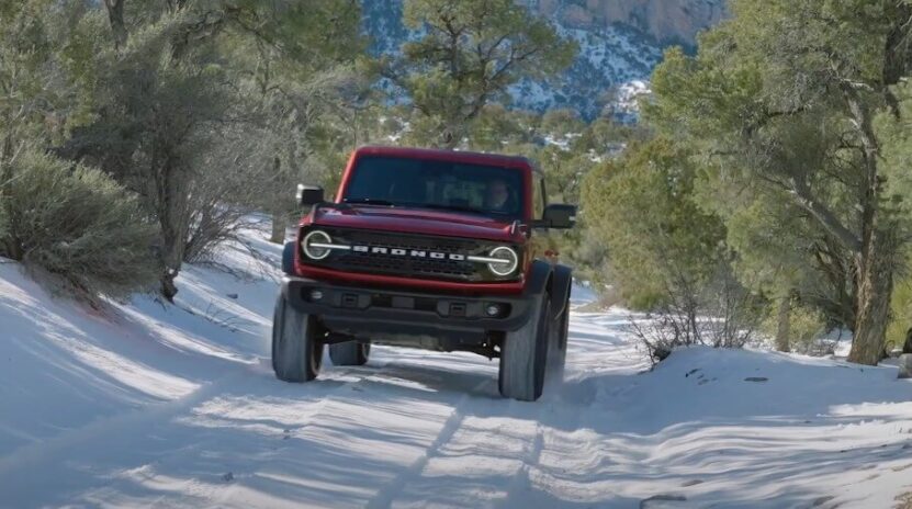 A Ford Bronco navigates a snowy trail
