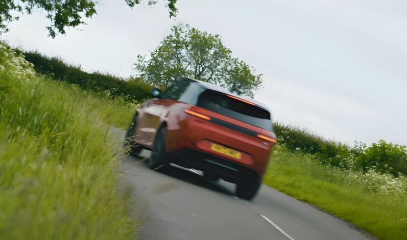 The Range Rover Sport SUV glides along a paved lane