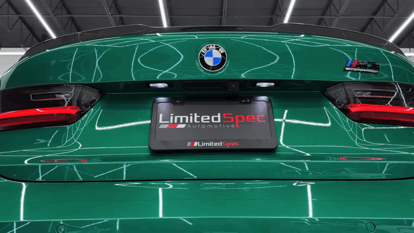 Back of a green BMW M3 Competition with a Limited Spec plate