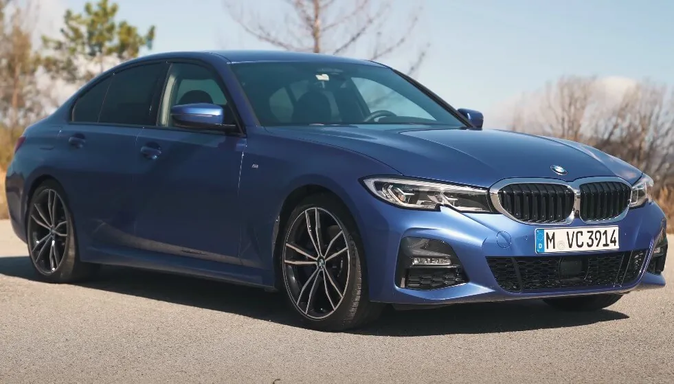 Blue BMW G20 parked on a paved road