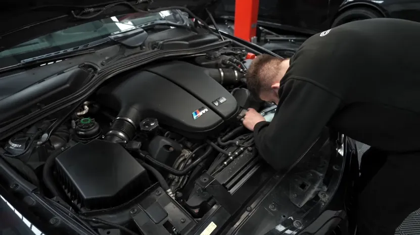 Mechanic inspects the BMW M6 S85 V10 engine