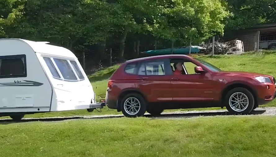 Red BMW X3 towing RV