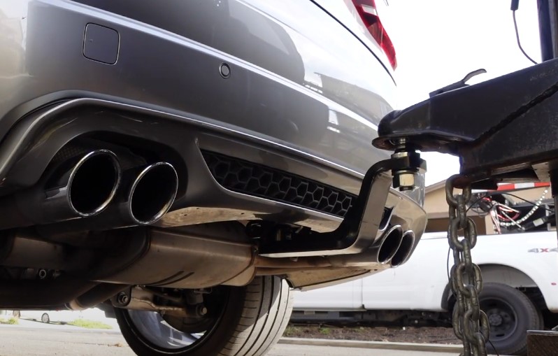 Tow hitch attached to a gray vehicle's rear bumper