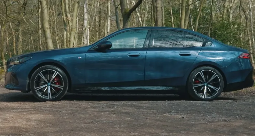 Sleek, modern sedan parked amidst a tranquil forest