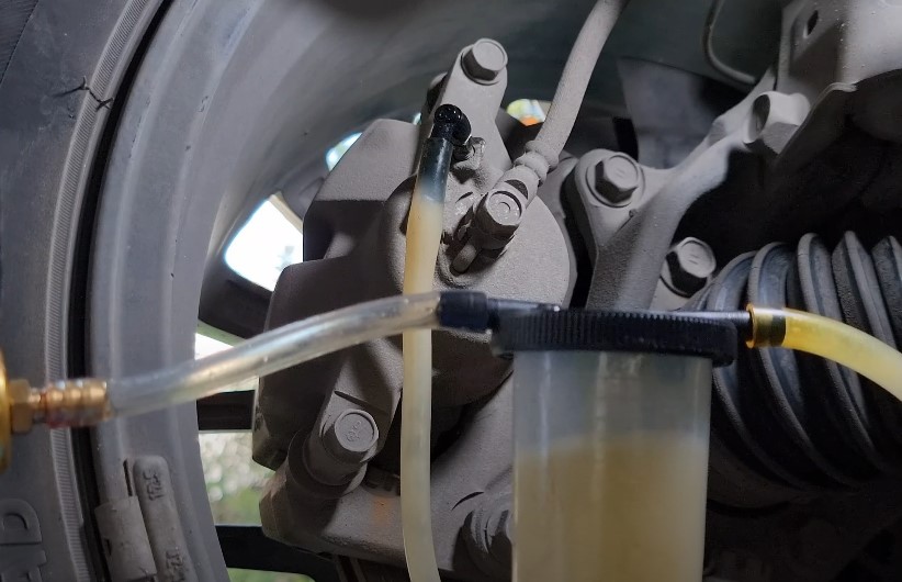 Brake fluid being flushed from the system