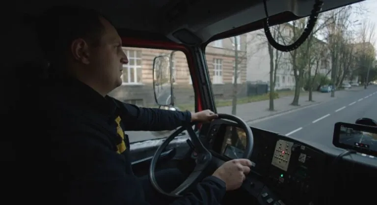 A truck driver navigates the city streets