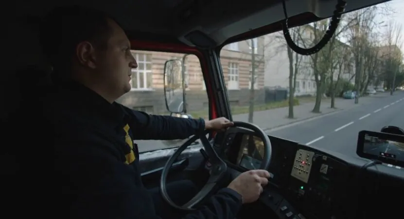 A truck driver navigates the city streets