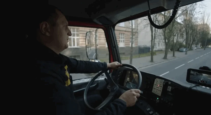 Truck driver drives through a city
