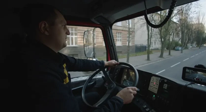 Truck driver drives through a city