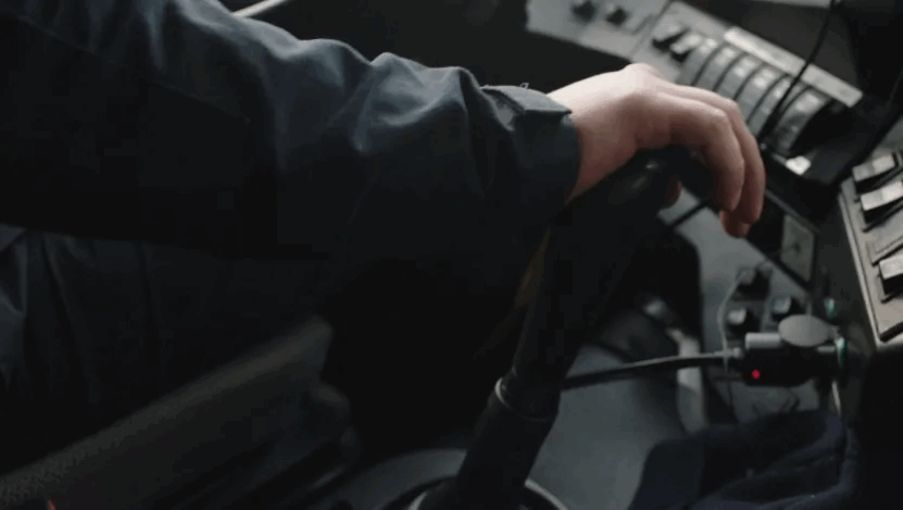 Close-up of a hand operating a vehicle's shift lever