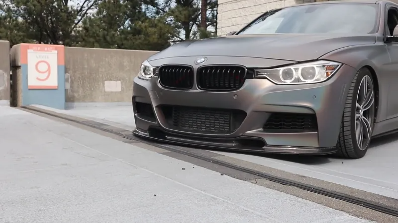 Front view of a BMW with protective edge trim applied to the front lip