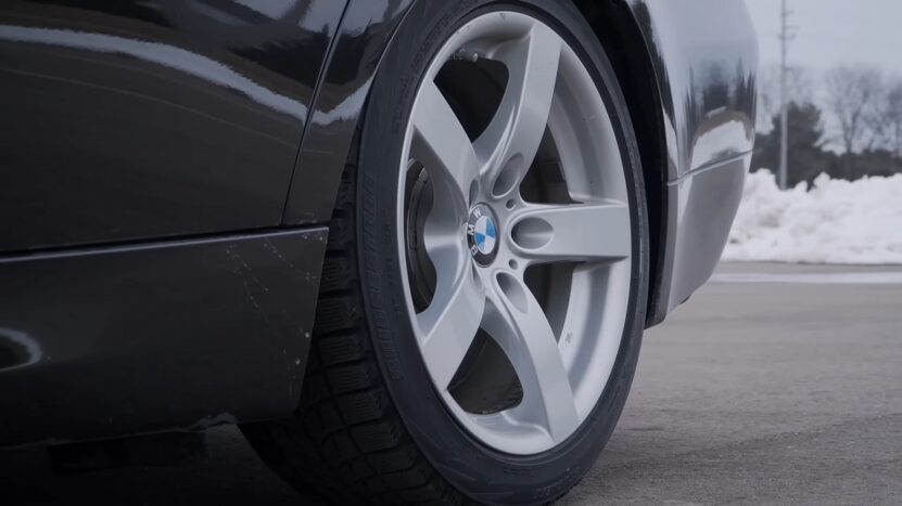 BMW sedan equipped with run flat tires and Bridgestone winter tread, parked near snow
