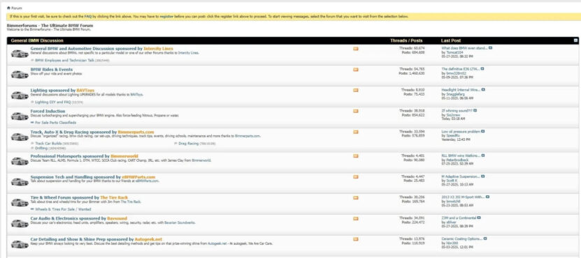Screenshot of the Bimmerforums online discussion board showing various BMW-related forum topics like lighting, racing, suspension, and app troubleshooting