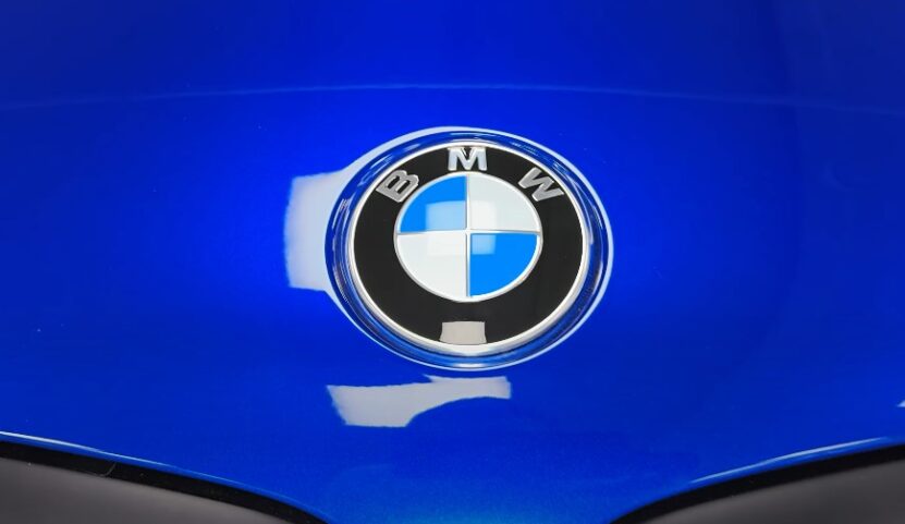 BMW emblem on a royal blue hood, close up view