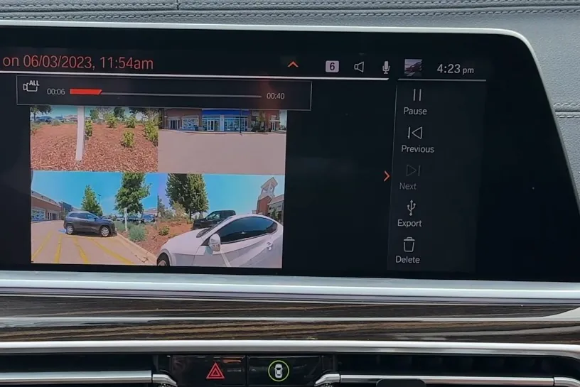 Car's dashboard display shows multiple parking lot views
