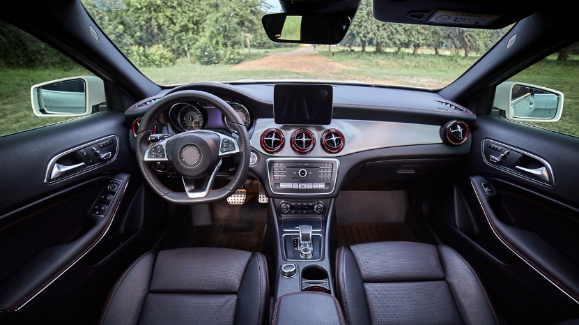 Black leather car interior with a modern dashboard and steering wheel