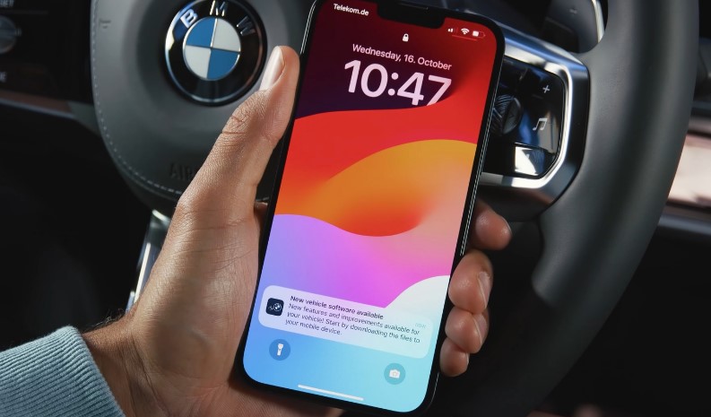 A smartphone displays a notification for new vehicle software updates