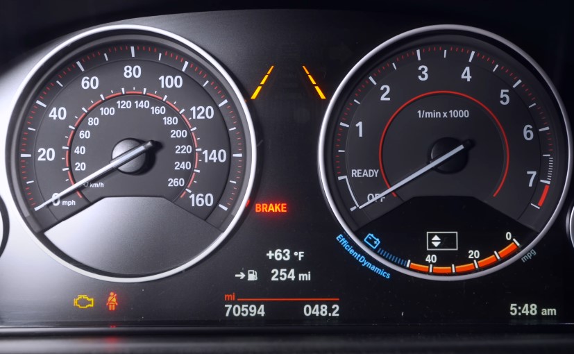 A vehicle's dashboard displays speed, fuel level, and time