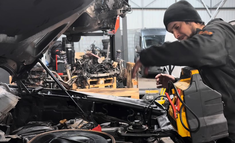 Close-up view of a technician working on a car engine