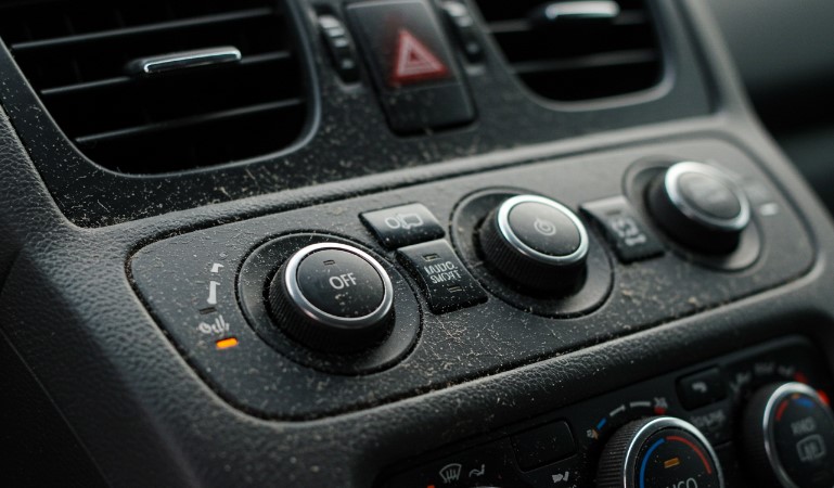 A fine layer of dust, clinging to the car's controls