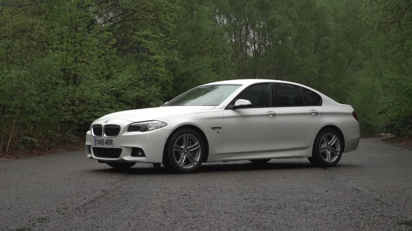 White BMW 5 Series F10 on a forest road, an example for F10 vs G30 comparison
