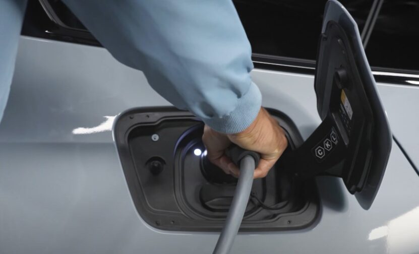 A person puts charger in electric BMW vehicle