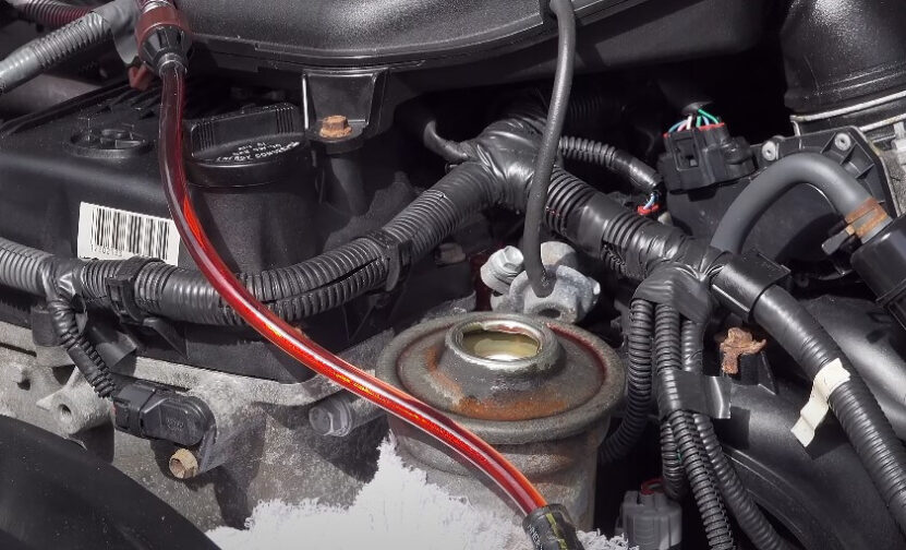 A close-up of a car engine featuring various wires and hoses connected to its components