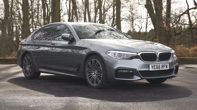 BMW 5 Series G30 parked on a forest road, compared in the F10 vs G30 lineup