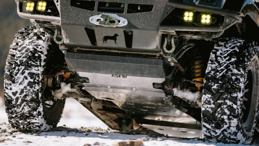 Close up view of SUV's skid plate in snowy tires