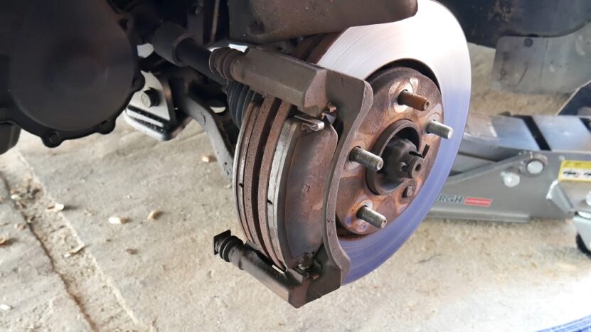 Exposed car brake system showing disc and caliper