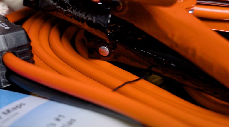 Bright orange cables coiled neatly, suggesting organized power or data transfer