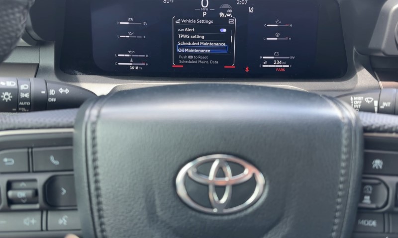 Close-up of a car dashboard displaying vehicle settings